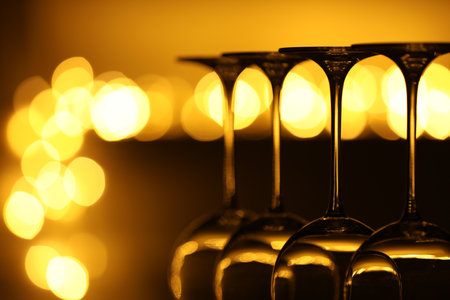 Many clean glasses against blurred lights, closeup. Bokeh effectの写真素材