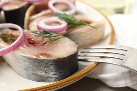 Pieces of delicious herring with onions and dill served on table, closeupの写真素材