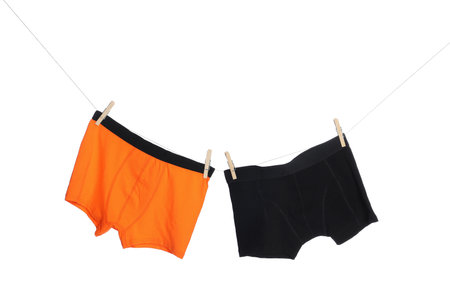 Comfortable men's underwear on clothes line against white backgroundの写真素材