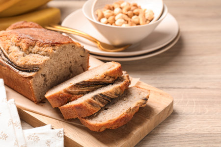 Pieces of banana bread with nuts on wooden table, closeup
