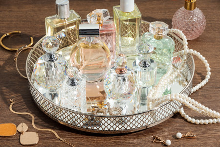 Different luxury perfumes and accessories on wooden tableの写真素材