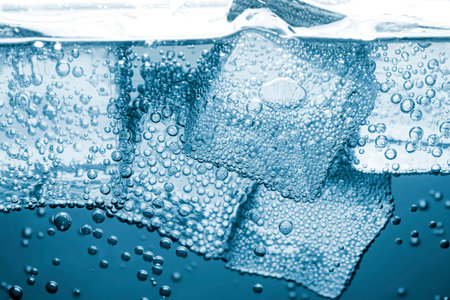 Soda water with ice cubes as background, closeup
