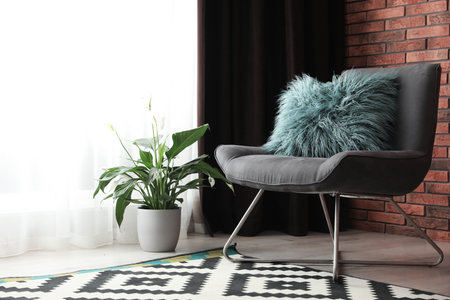 Comfortable chair near window with elegant curtains in roomの写真素材