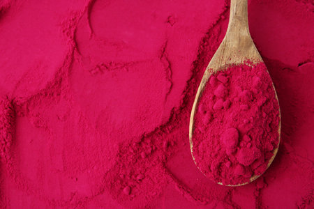 Superfood product. Beetroot powder and spoon as background, closeupの写真素材