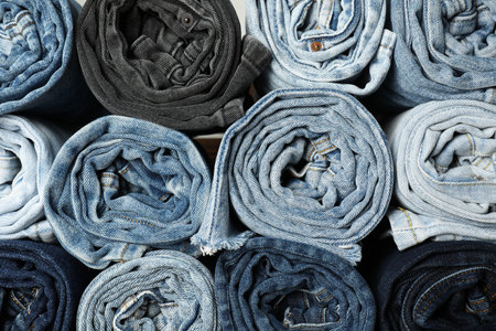 Different stylish rolled jeans as background, top viewの写真素材