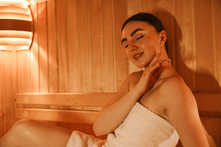 Beautiful woman wrapped in towel at saunaの写真素材