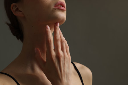 Woman on gray background, closeup. Space for textの写真素材