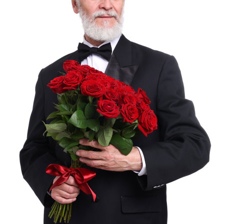 Senior man with bouquet of red roses on white background, closeupの写真素材