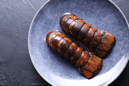 Raw lobster tails on black table, top viewの写真素材