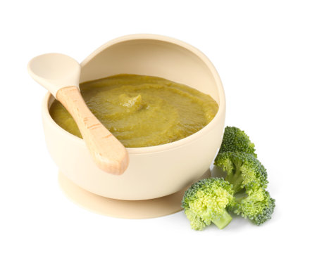 Baby food. Tasty puree in bowl, broccoli and spoon isolated on whiteの写真素材
