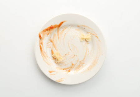 Dirty plate on white background, top viewの写真素材