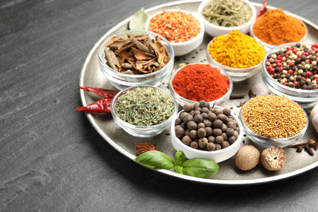 Different aromatic spices on black table, closeup. Space for textの写真素材