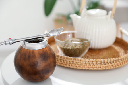 Traditional yerba mate tea on white table indoors, closeup