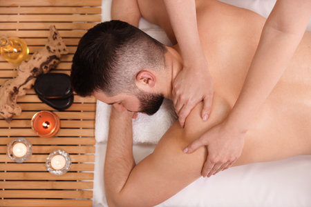 Man receiving relaxing massage in spa salon, top viewの写真素材
