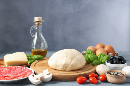 Making pizza. Different ingredients on gray wooden tableの写真素材