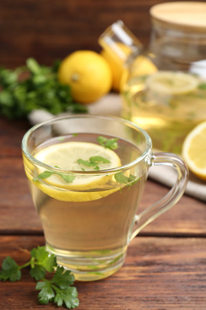 Healthy parsley tea with lemon slices on wooden table. Detox drinkの写真素材