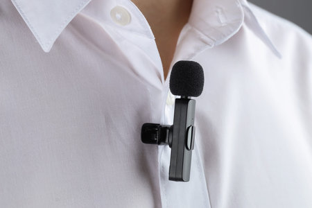 Man with lavalier microphone attached to his shirt, closeup