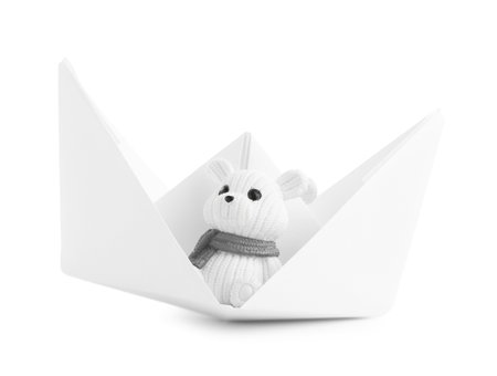 Paper boat with toy bear isolated on whiteの写真素材