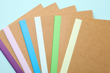 Many different copybooks on light blue background, flat layの写真素材