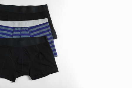 Comfortable men's underwear on white background, flat lay. Space for textの写真素材