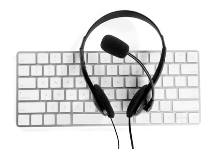 Headset with microphone and keyboard on white background, top viewの写真素材