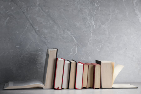 Different old books on light grey marble tableの写真素材