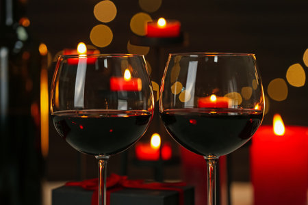 Glasses of red wine against blurred background, closeup. Romantic dinnerの写真素材