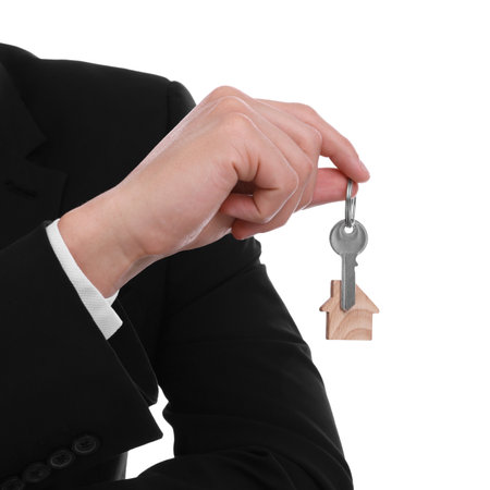 Real estate agent with house key on white background, closeupの写真素材