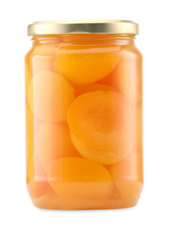 Tasty canned apricots in jar isolated on whiteの写真素材