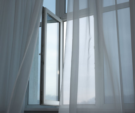 Open window and elegant white curtains indoors. Interior design