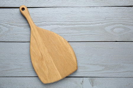 One cutting board on grey wooden table, top view. Space for textの写真素材