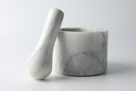 Marble mortar with pestle on white background, closeupの写真素材