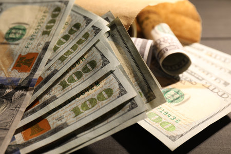 Paper money bag with dollar banknotes on table, closeupの写真素材