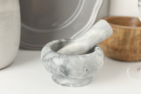 Marble mortar and pestle on white table indoors, closeupの写真素材