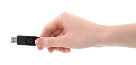 Woman holding usb flash drive on white background, closeup