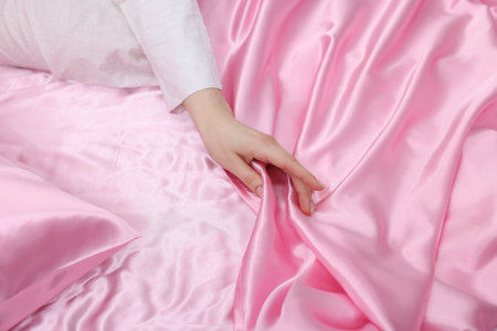 Woman with bed pink silk lines, closeupの写真素材