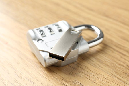 Flash drive and combination padlock on wooden background, closeupの写真素材