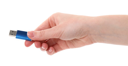 Woman holding usb flash drive on white background, closeup