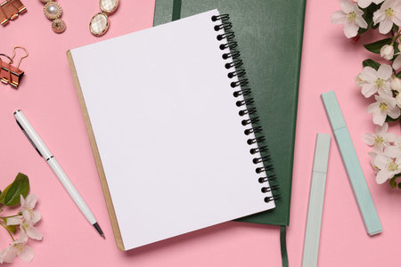 Planner and stationery on pink background, flat lay