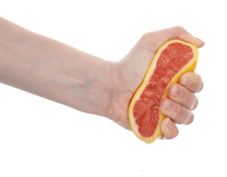 Woman squeezing grapefruit on white background, closeupの写真素材