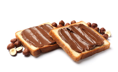 Toasts with tasty chocolate hazelnut spread and nuts isolated on whiteの写真素材