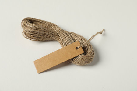 Blank tag with strings on white background, closeupの写真素材