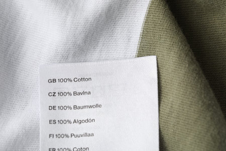 Clothing label with material content on color garment, above viewの写真素材