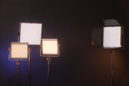 Professional lighting equipment on dark background with color lightsの写真素材