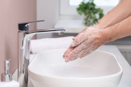 Woman washing her hands with foaming soap above sink in bathroom, closeupの写真素材