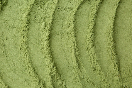 Superfood. Wheat grass powder as background, top view