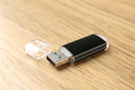 One flash drive on wooden background, closeup. Space for textの写真素材