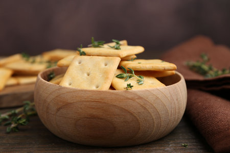 Tasty crackers with thyme on wooden table, closeupの写真素材