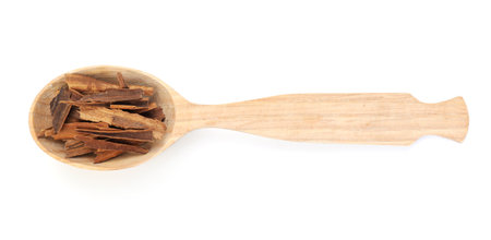 Aromatic cinnamon in wooden spoon isolated on white, top viewの写真素材