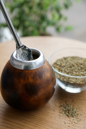 Traditional yerba mate tea on wooden table indoors, closeup